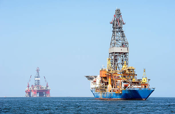 Oil industry parking, Walvis Bay, Namibia, Africa Oil exploration survey vessel and self propelled oil rig from Angolan oil fields for cheaper parking at Walvis Bay, Namibia, Africa Oil Industry in Africa stock pictures, royalty-free photos & images